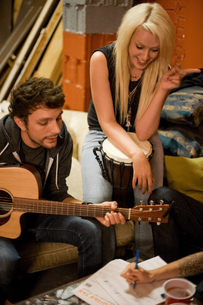 Indie band performing on a small stage with a live audience