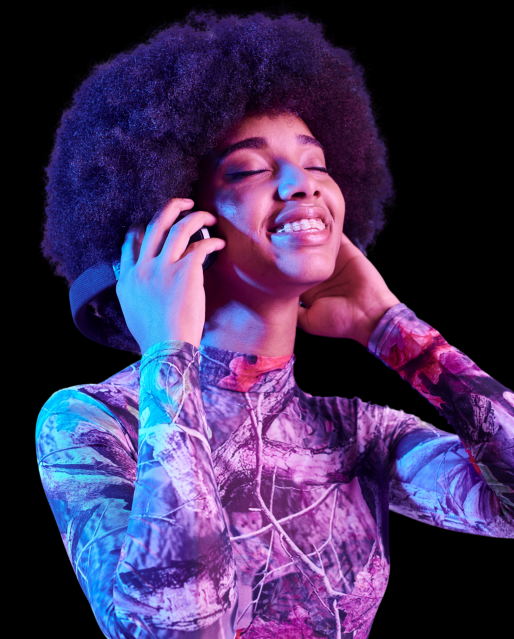 A woman enjoying music with headphones, representing the impact of music discovery and organic growth.